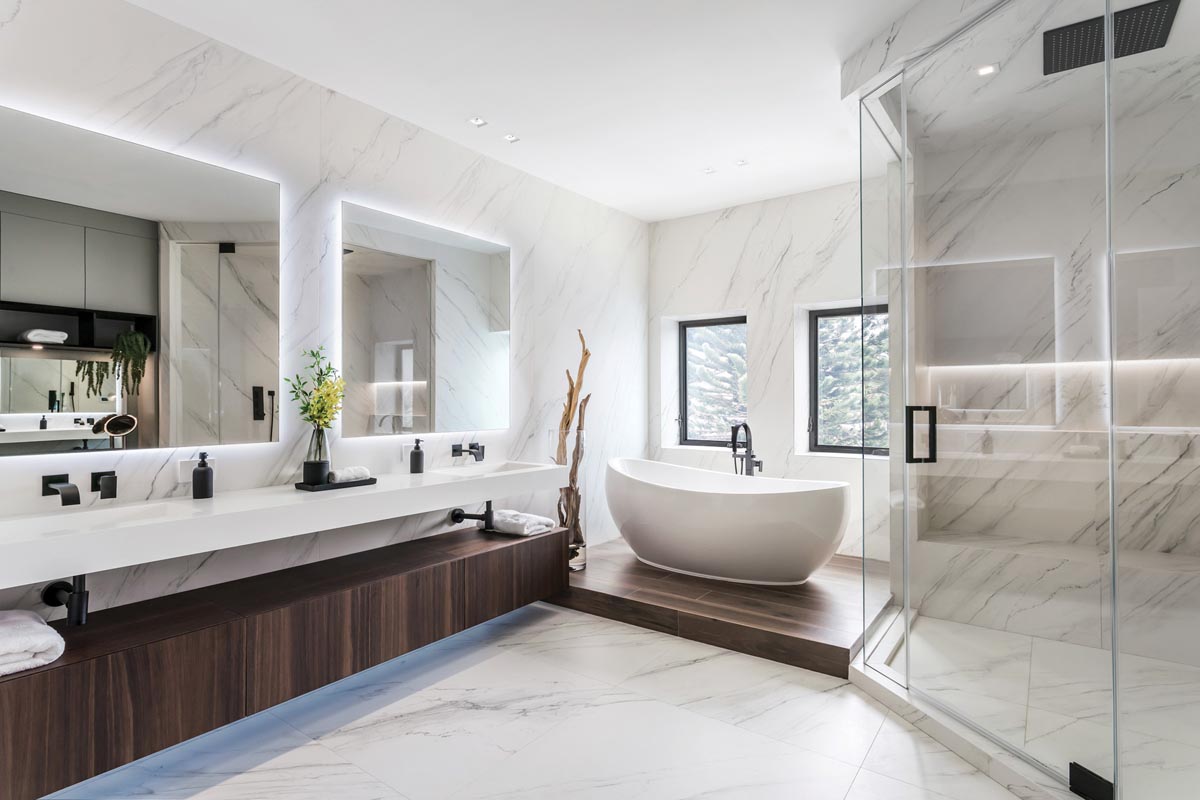 MiaCucina created the floating cabinetry for the primary bathroom, while the bathtub came from Maison Kitchen + Bath. The porcelain slabs were sourced from BKF Decor Solutions.