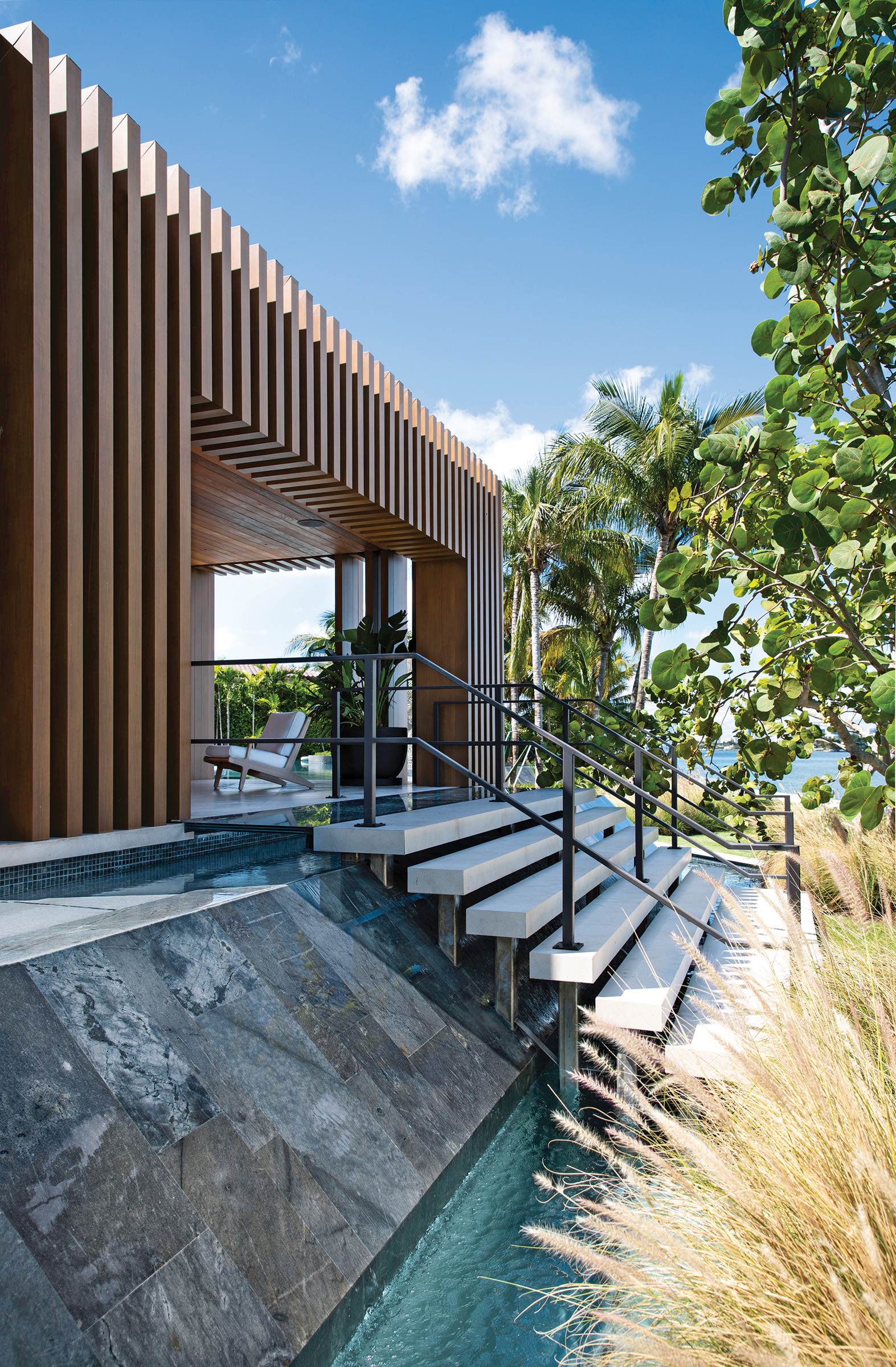 A set of stairs leads to a cabana surrounded by seagrape trees.