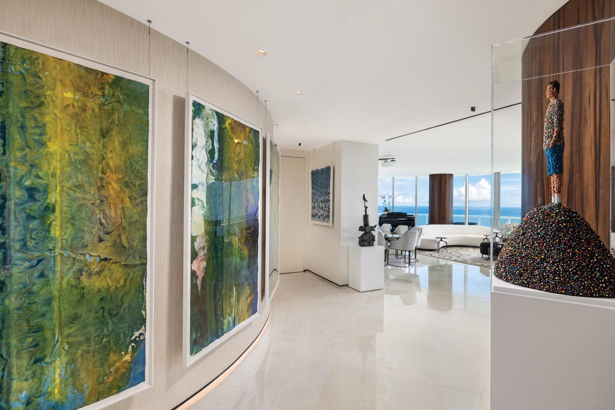 A trio of untitled watercolors on rice paper by American abstractionist Sam Gilliam lead the eye toward the condo’s living room.