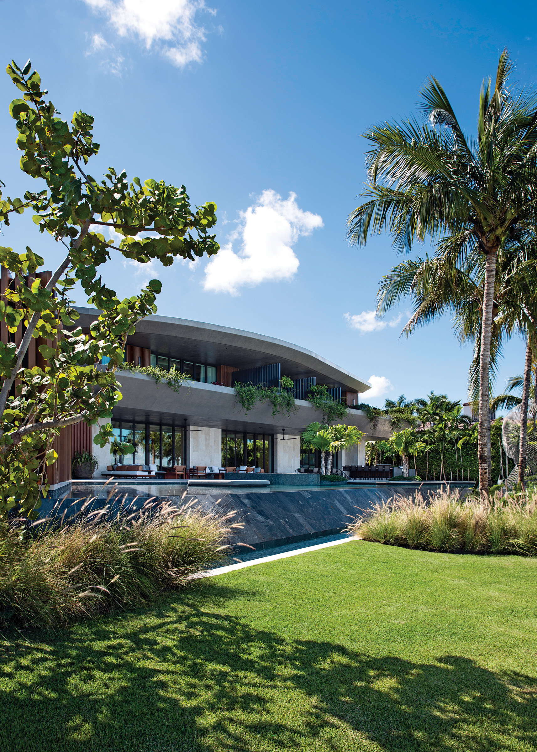 A view of the raised pool area reveals the use of seagrape, coconut palms, and fountain grass.