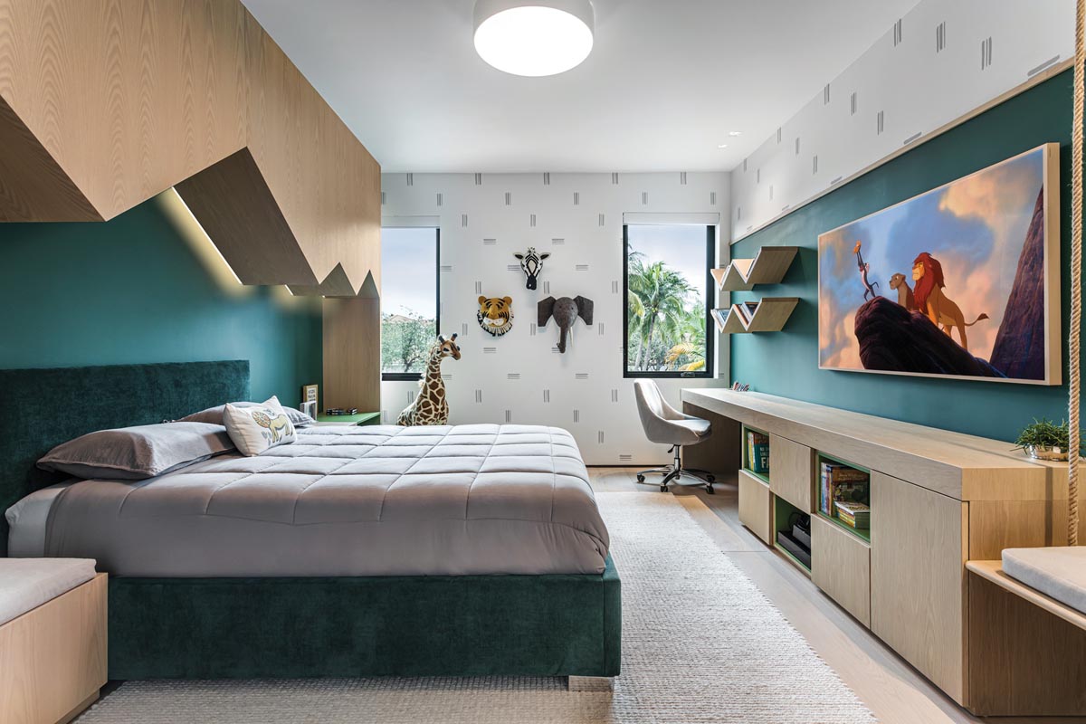 Although this animal-themed bedroom is a dream-come-true for the homeowners’ youngest son, the designers created it with the future in mind. “He can grow into it,” says Simoes. “The wallpaper has no animals—it’s just white and gray—and they can easily remove the headboard.”