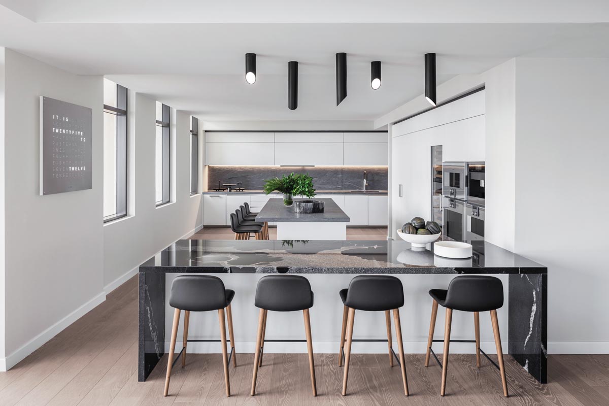 An Italian luxury kitchen by Boffi makes a chic style statement for this state-of-the-art gathering hub. Seamless cabinetry and built-in stainless-steel appliances enhance the home’s clean linear feel, and double islands provide ample seating for family and guests.