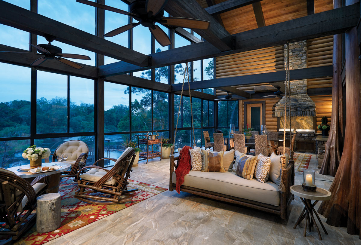 The river-facing back porch was originally supposed to be open to the elements. But because of the summer heat, Sanchez decided to glass it in and add air conditioning for a comfortable gathering spot that includes a rustic porch swing, areas for lounging, and a kitchen with stone accents.