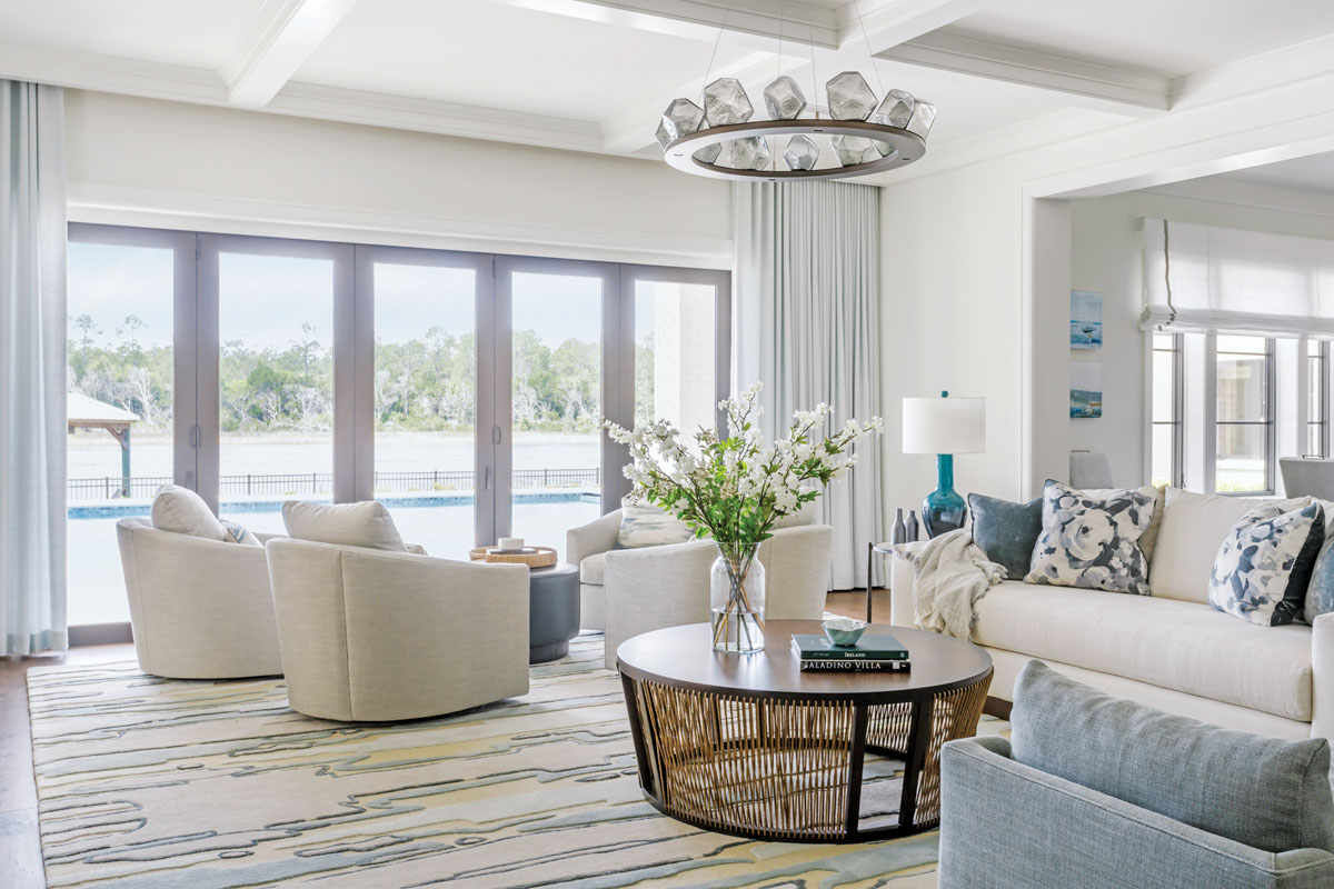 Interior designer Amanda Webster and project manager Anna DeRita leveraged the volume of the living room to create two seating areas to relax and visit. This quartet of swivel chairs offers some of the best water views in the house.