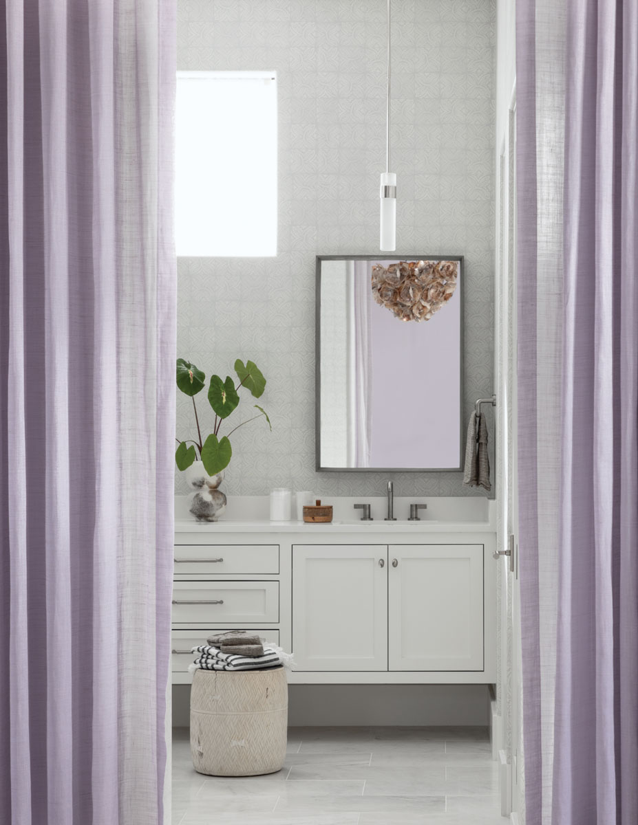 Booth believes drapery isn’t strictly for windows. It’s a softening device that creates a little bit of theater. Here, Booth uses it instead of a barn door to separate the master bath from the master bedroom.
