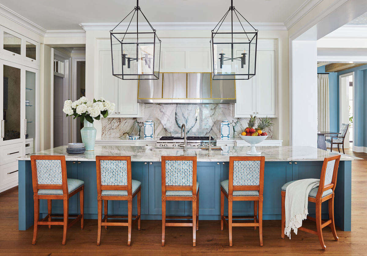 Butterfly-matched Tiffany-blue natural quartzite slabs were used to create a captivating island top and backsplash for this kitchen that bucks the all-white kitchen trend.