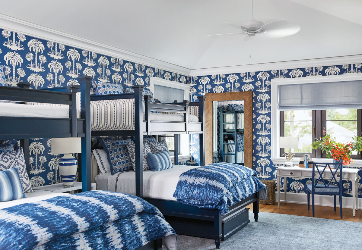 The children’s bedroom’s bold play on navy and white, in everything from the Thibaut wallpaper to the batik-dyed comforters and Eastern Accent array of bedding pillows, makes it a crisp and fresh space that’s ideal for the family’s youngest members.