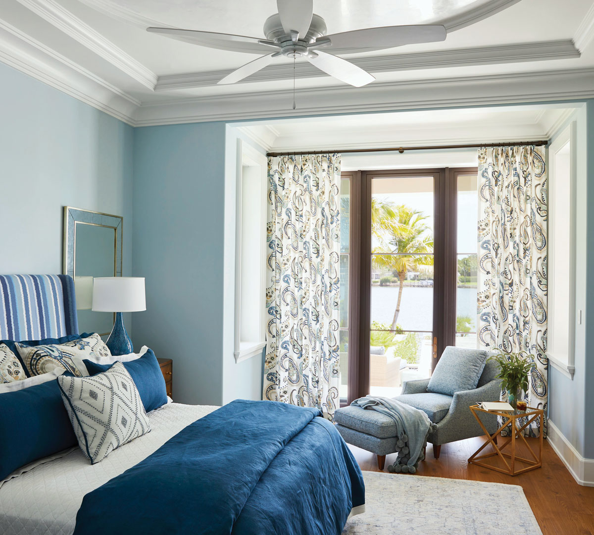 Each bedroom was designed to have its own vibe and special qualities. In this serene aqua and tan space, a chaise and ottoman from Highland House and a side table from Peach Tree Designs create a beguiling opportunity for moments of mindfulness.