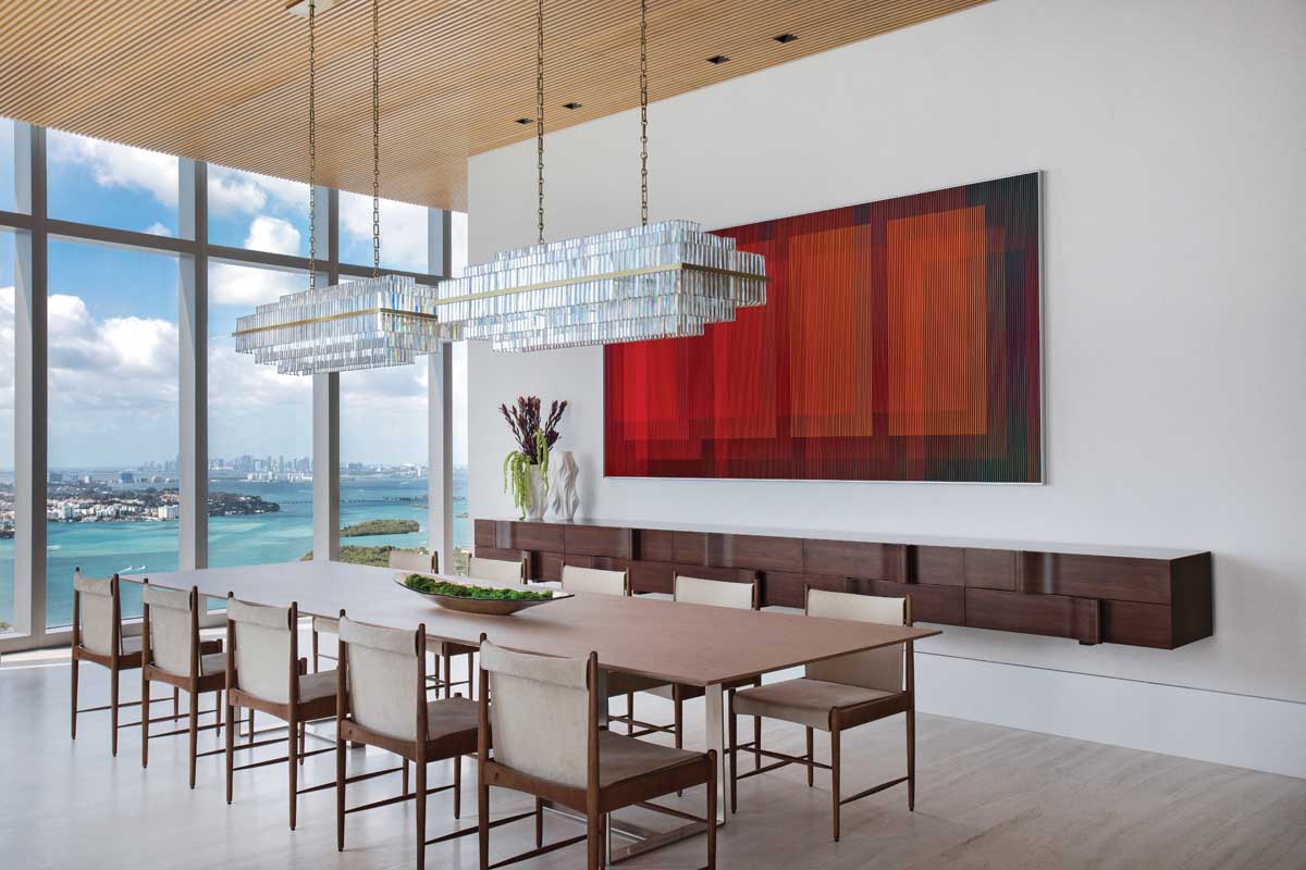 Physichromie Panam 319 by Venezuelan artist Carlos Cruz-Diez stars as part of a sophisticated ocean-facing scene, alongside an Arthur Casas floating walnut console, a long table from Artefacto, and Cantu chairs by legendary Brazilian designer Sergio Rodrigues. The multi-tiered linear crystal chandeliers were sourced from The Lighting Studio.