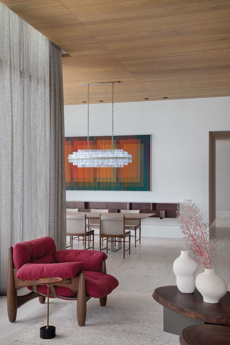 “The client’s favorite color is red,” says designer Jessica Jaegger of the decorative Mole chair by Sergio Rodrigues, accompanied by a Jardim side table by Jader Almeida.
