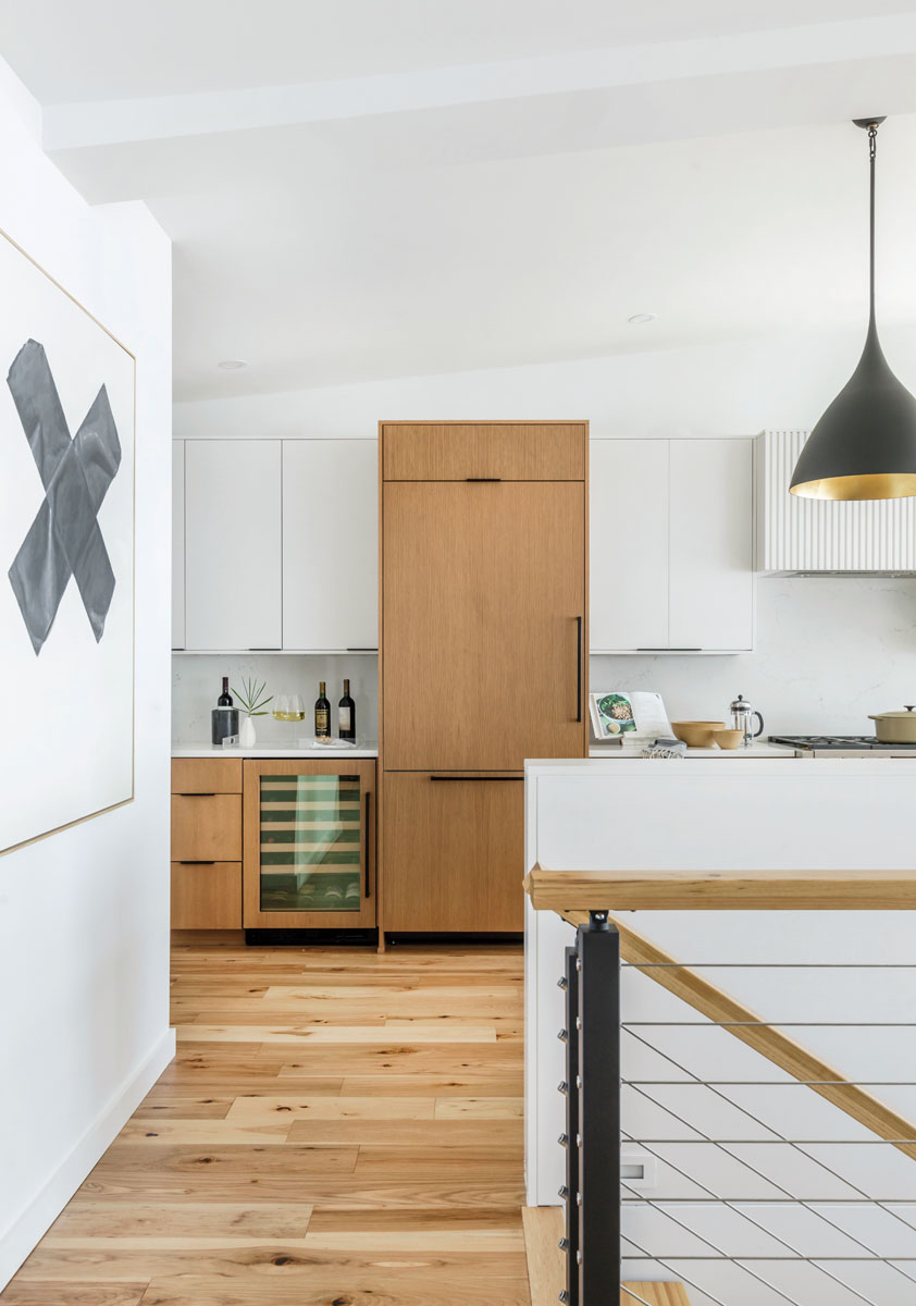 In the kitchen, clean lines marry the mix of white and light wood used on the cabinets and appliances.