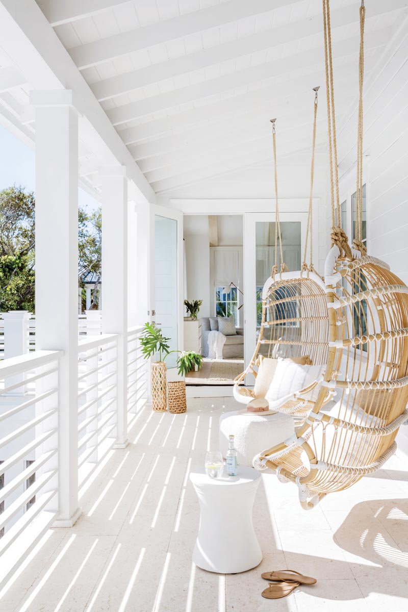 A private terrace off the primary bedroom invites the homeowners to unwind on Serena & Lily hanging chairs and enjoy the property’s courtyard views.