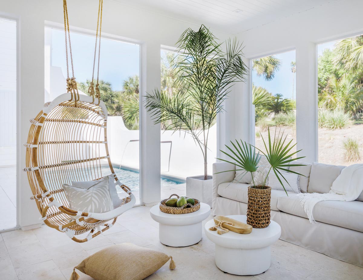 An outdoor hanging chair from Serena & Lily is the focal point of this indoor/outdoor room, which is the husband’s favorite spot for hanging out with the family.