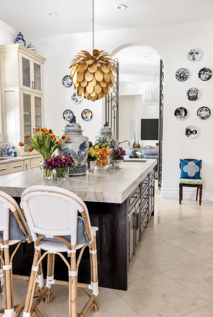 The homeowners and design team opted to keep the existing kitchen cabinetry and countertops intact, so accessories were added for a punch of personality. “The big ginger jars on the kitchen island are from a recent trip I took to New Orleans,” says Alonso. “I sourced for this project from everywhere!”