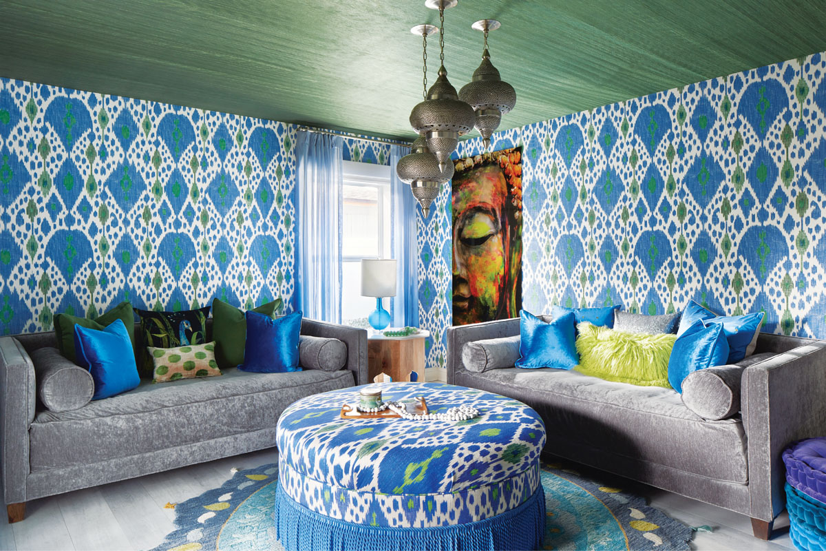 Robyn Branch_FD31-2D Photography by Zeke Ruelas Photography, Nashville, TN In the first floor guest den, Branch nudged the homeowner toward a more Moroccan-inspired look rich with deep greens and blues. Three pendants hang from the ceiling at staggered lengths, while the green-and-blue wallpaper brings the outside in. Floor cushions and throw pillows make it a perfect, quiet spot for the homeowner to meditate.
