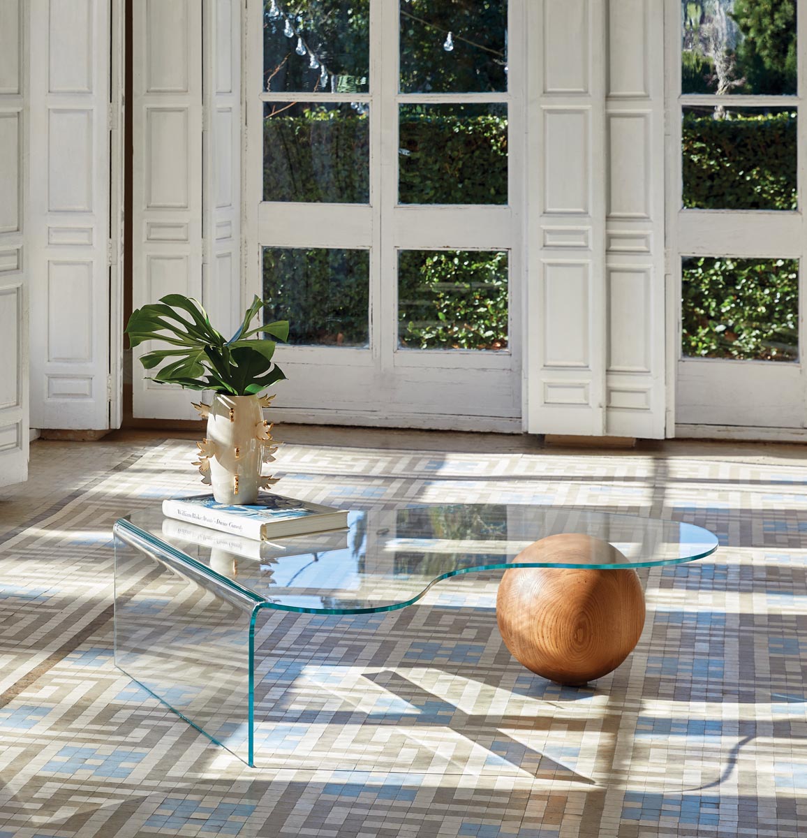 The GlobeWoo coffee table offers a pairing of glass and wood that’s both whimsical and elegant