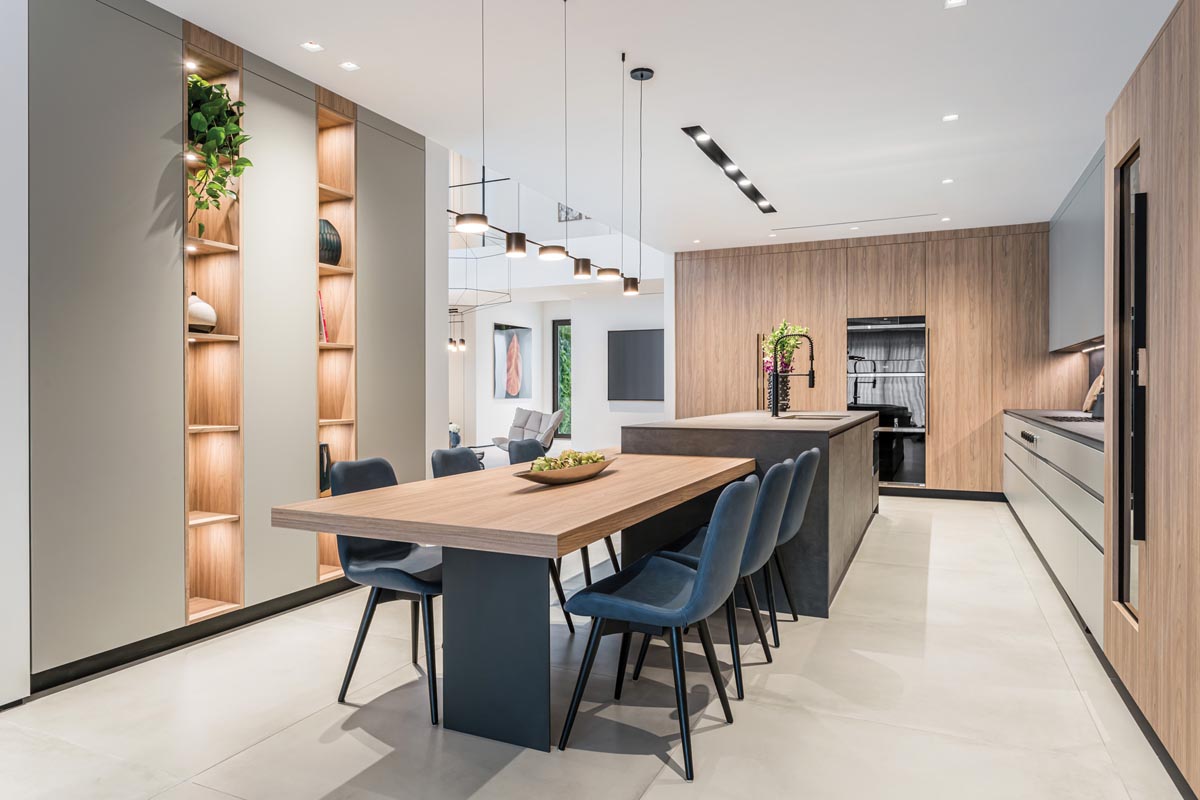The design team worked with MiaCucina to make the kitchen a perfect marriage of modern and organic elements, integrating slate countertops, dove gray and oak cabinets, and stark black fixtures. Chairs from Addison House and lighting from The Lighting Studio of 30A complete the look.