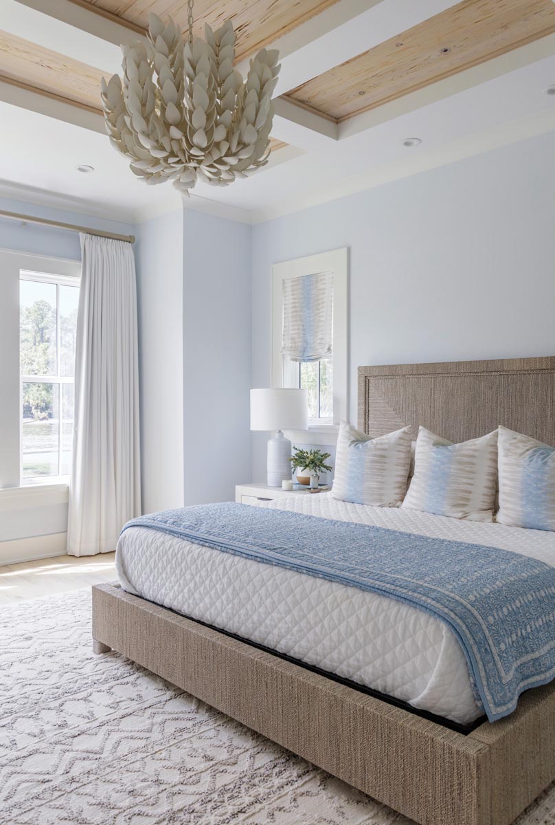 The tile selected was a jumping off point for the color scheme of the primary bedroom. “A special light can elevate the entire space,” says Leonard of the Palecek chandelier here, which is both beach-inspired and sophisticated.
