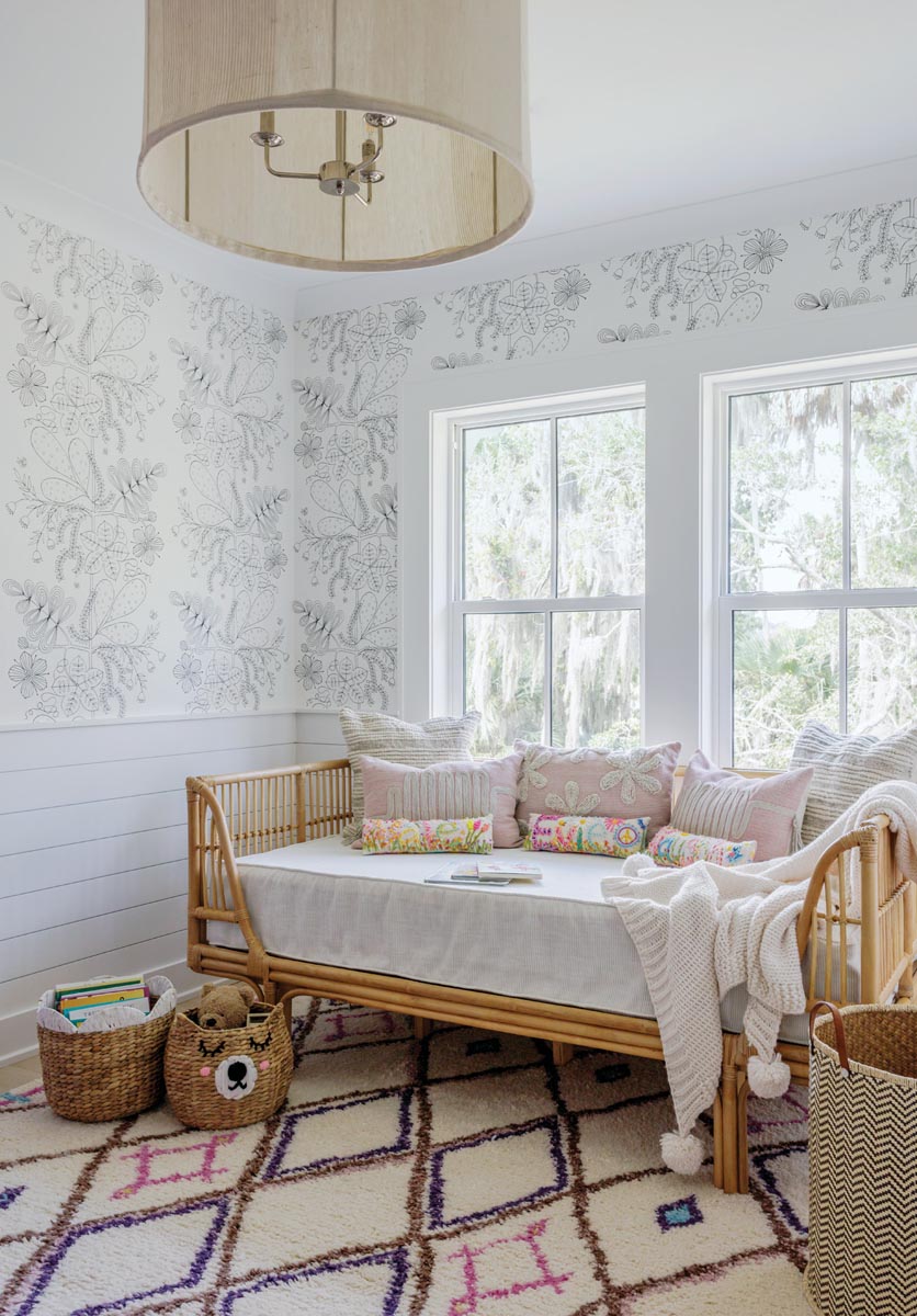 With its black-and-white botanical wallpaper and rattan boho daybed, the girls’ hangout room makes its purpose clear.